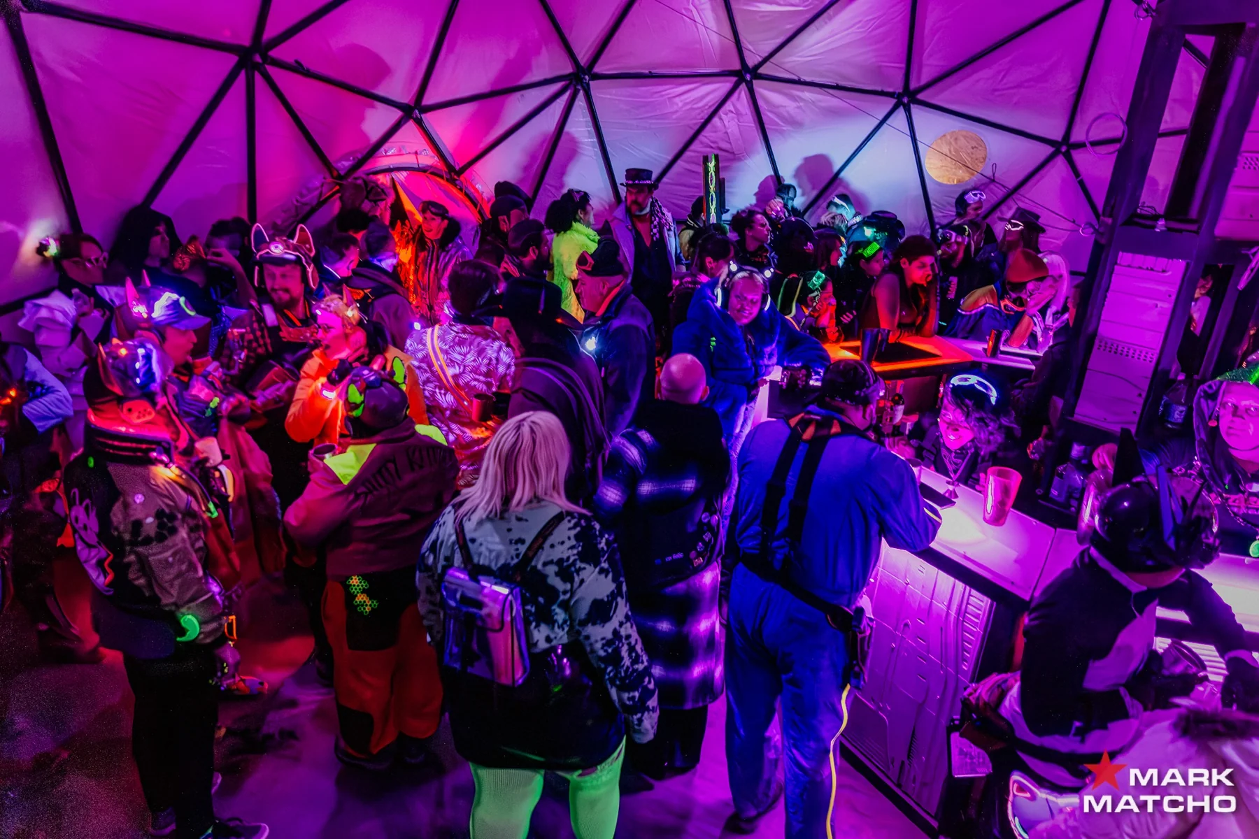 Guests gathered inside Maintenance Bay 54's illuminated event space